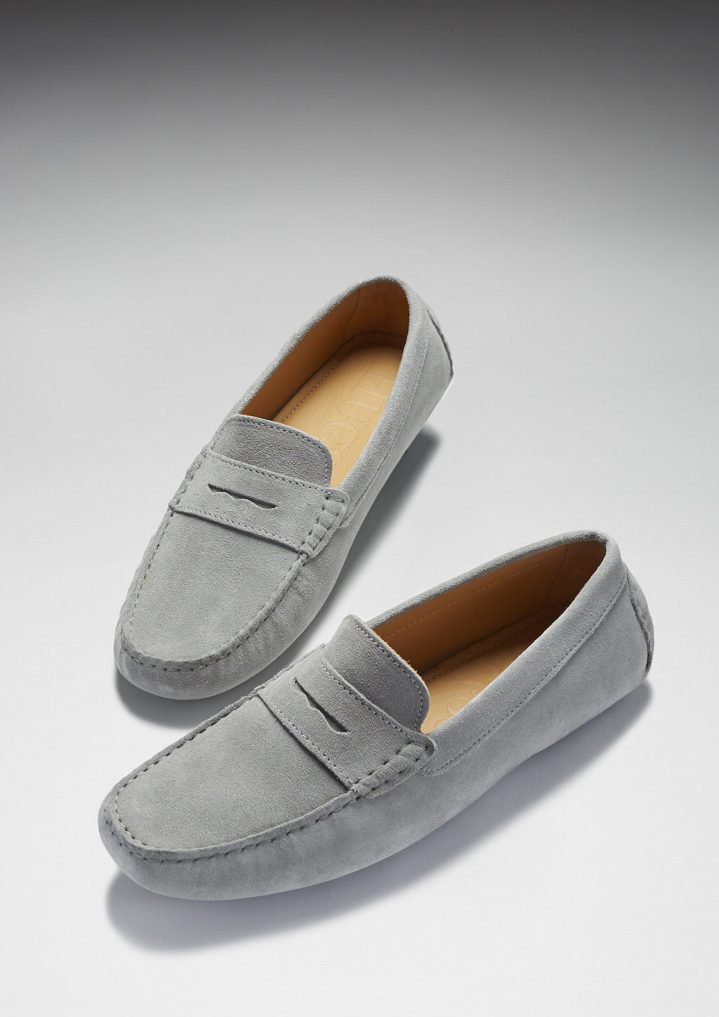 Pair of gray loafers on a light gray background