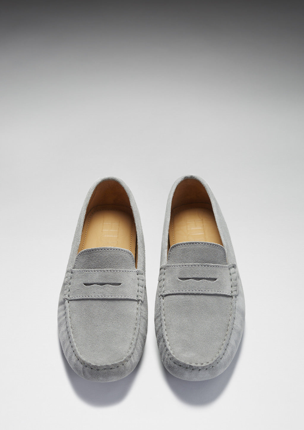 Pair of gray loafers on a white background