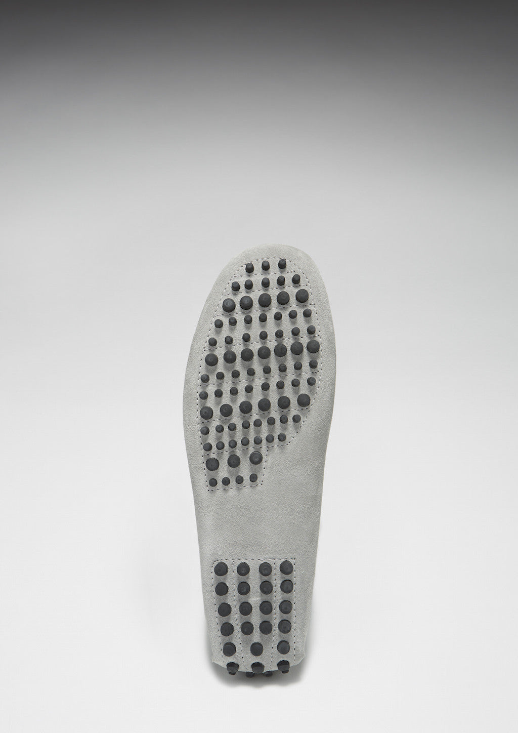 Gray shoe sole with textured bottom on a white background