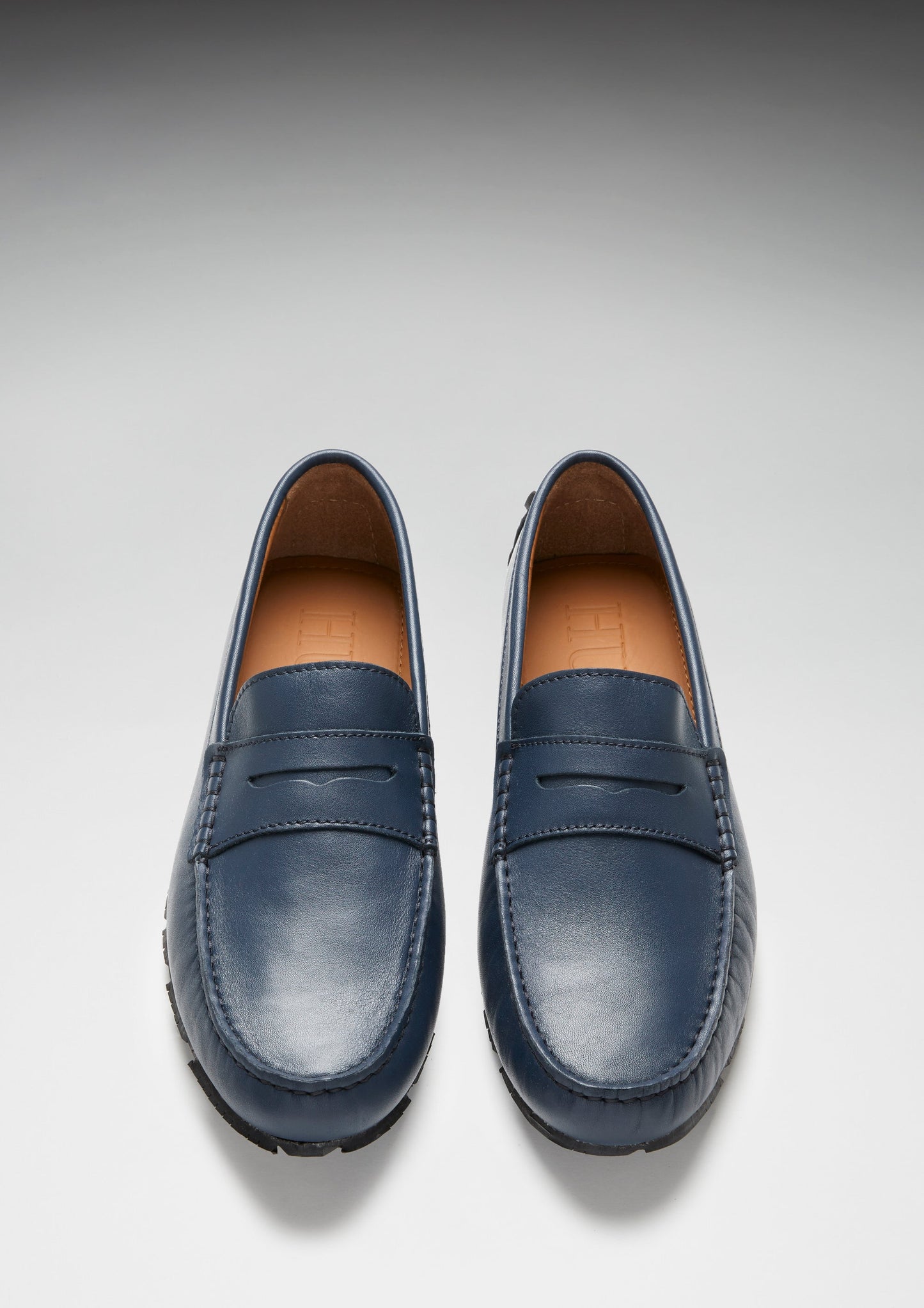 Pair of blue loafers on a light gray background