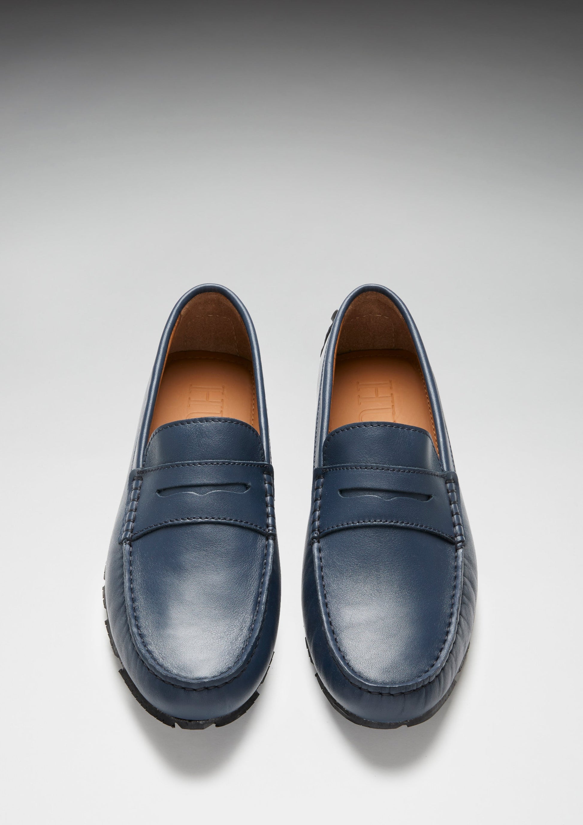 Pair of blue loafers on a light gray background