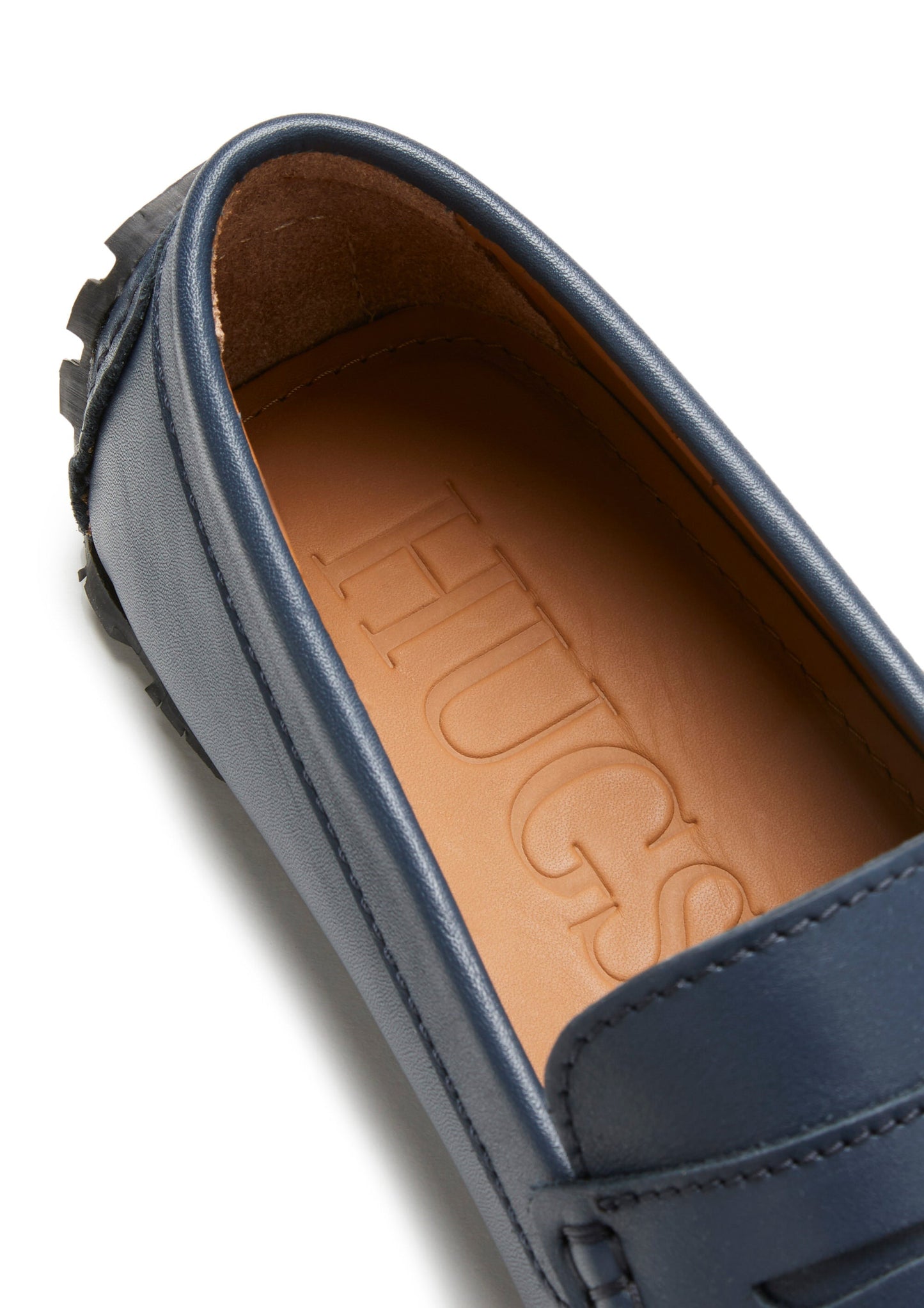 Close-up of a blue loafer with branding on the insole.