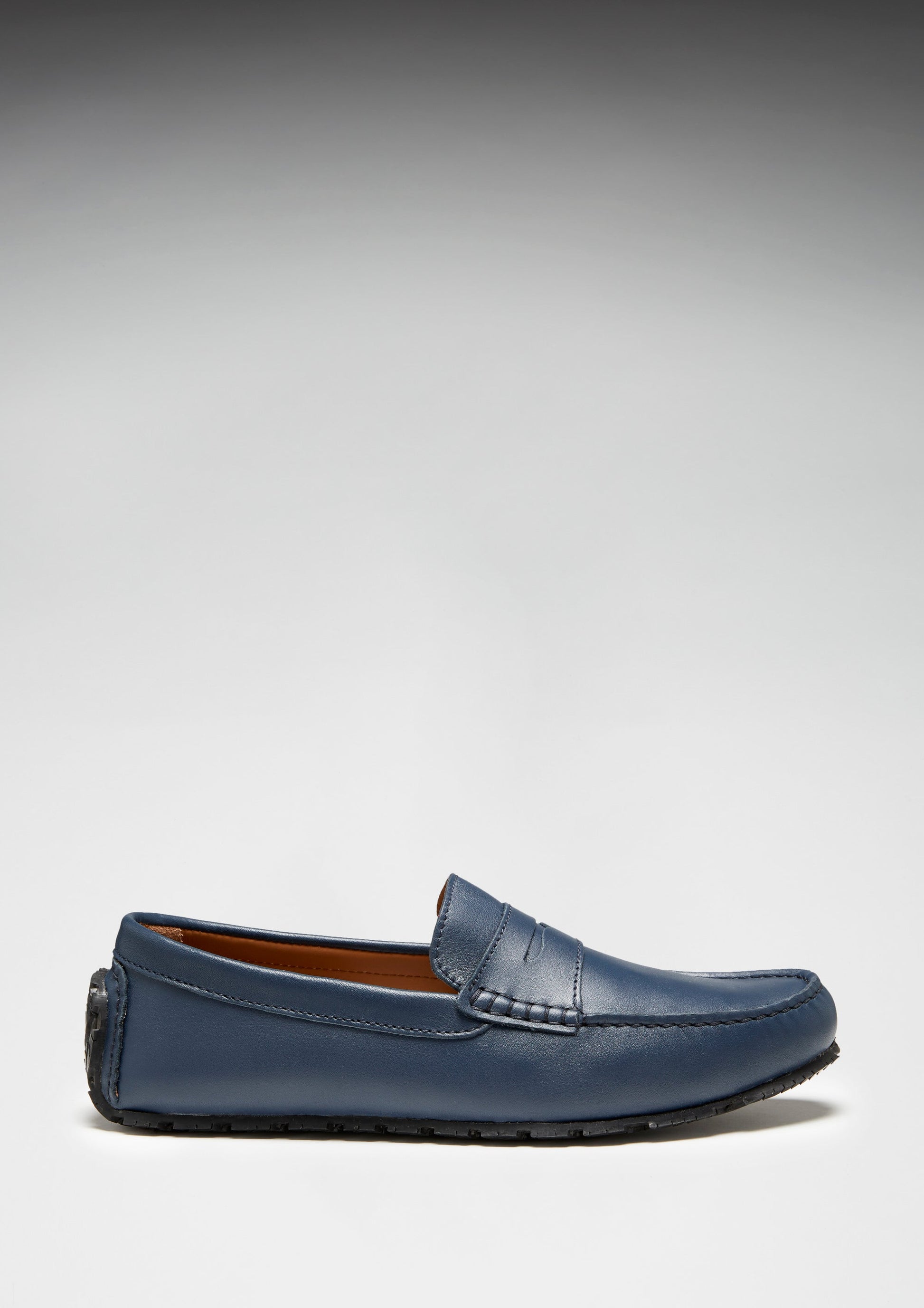 Blue loafer shoe on a light gray background