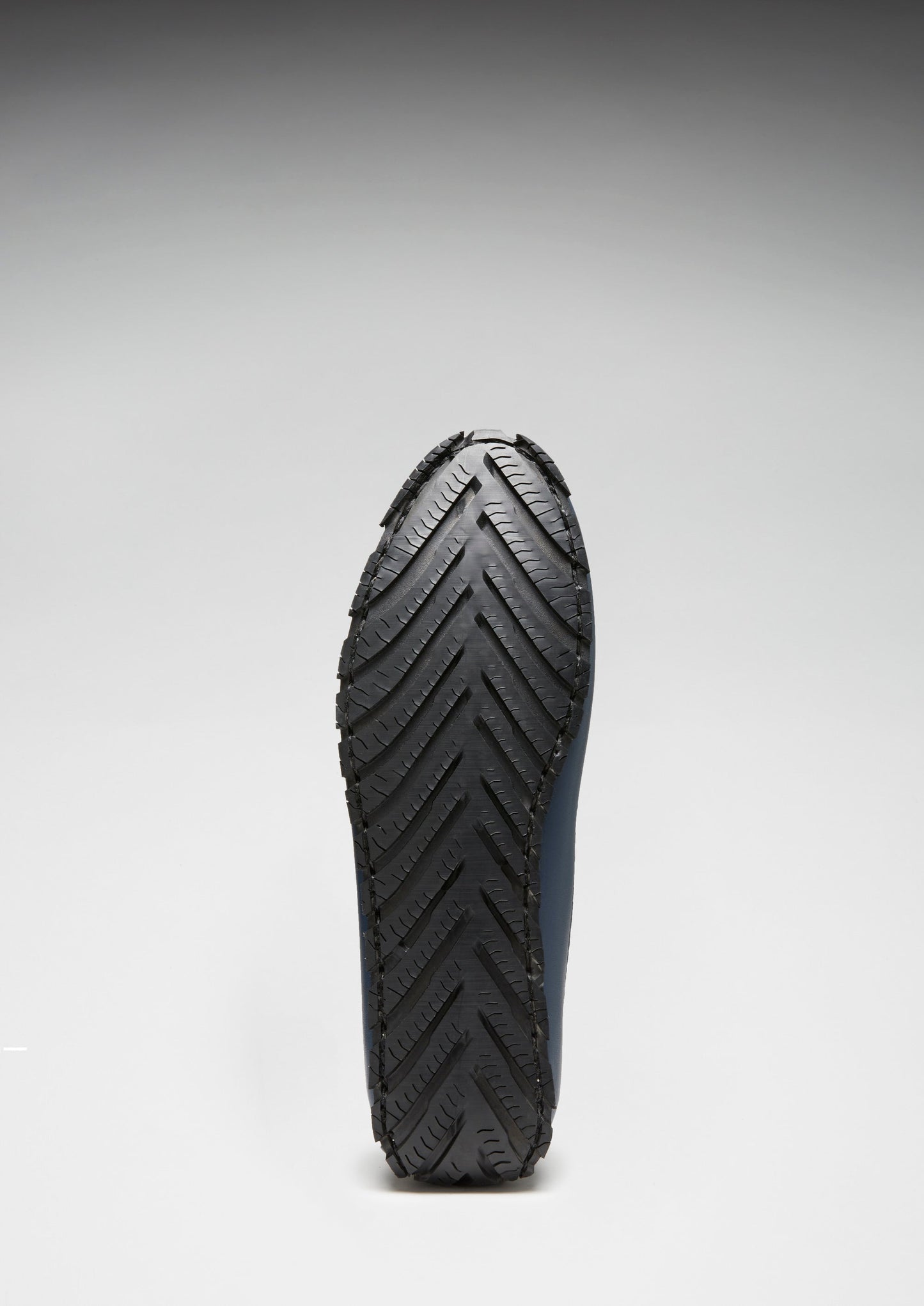 Close-up of a black rubber sole on a white background