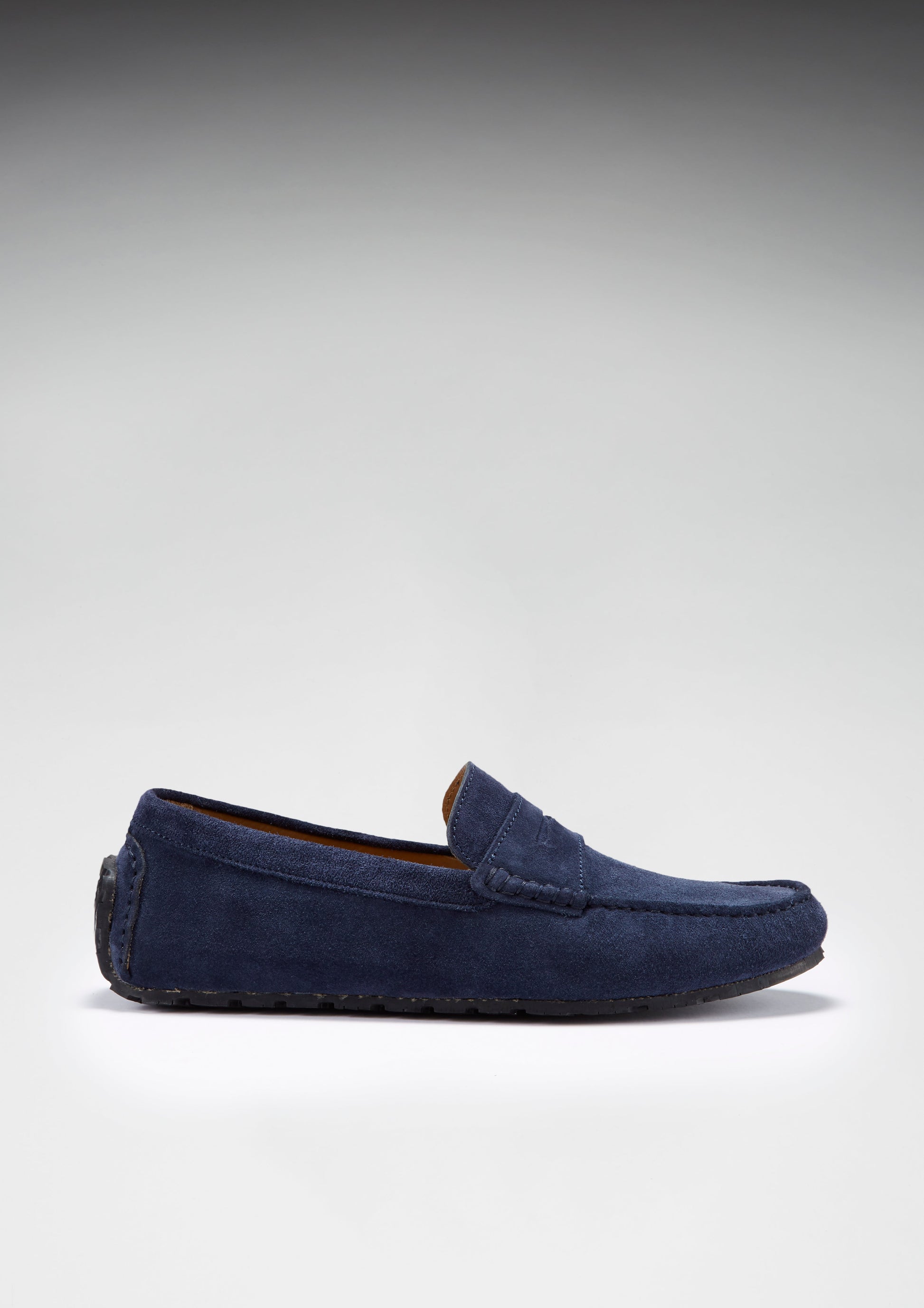 Navy blue loafer shoe on a light gray background