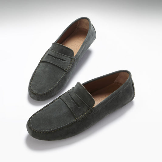 Pair of gray suede loafers on a white background