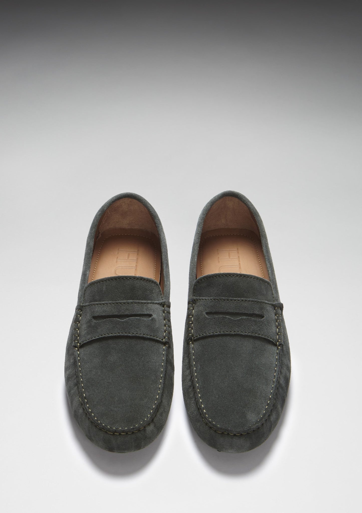 Pair of gray loafers on a light gray background