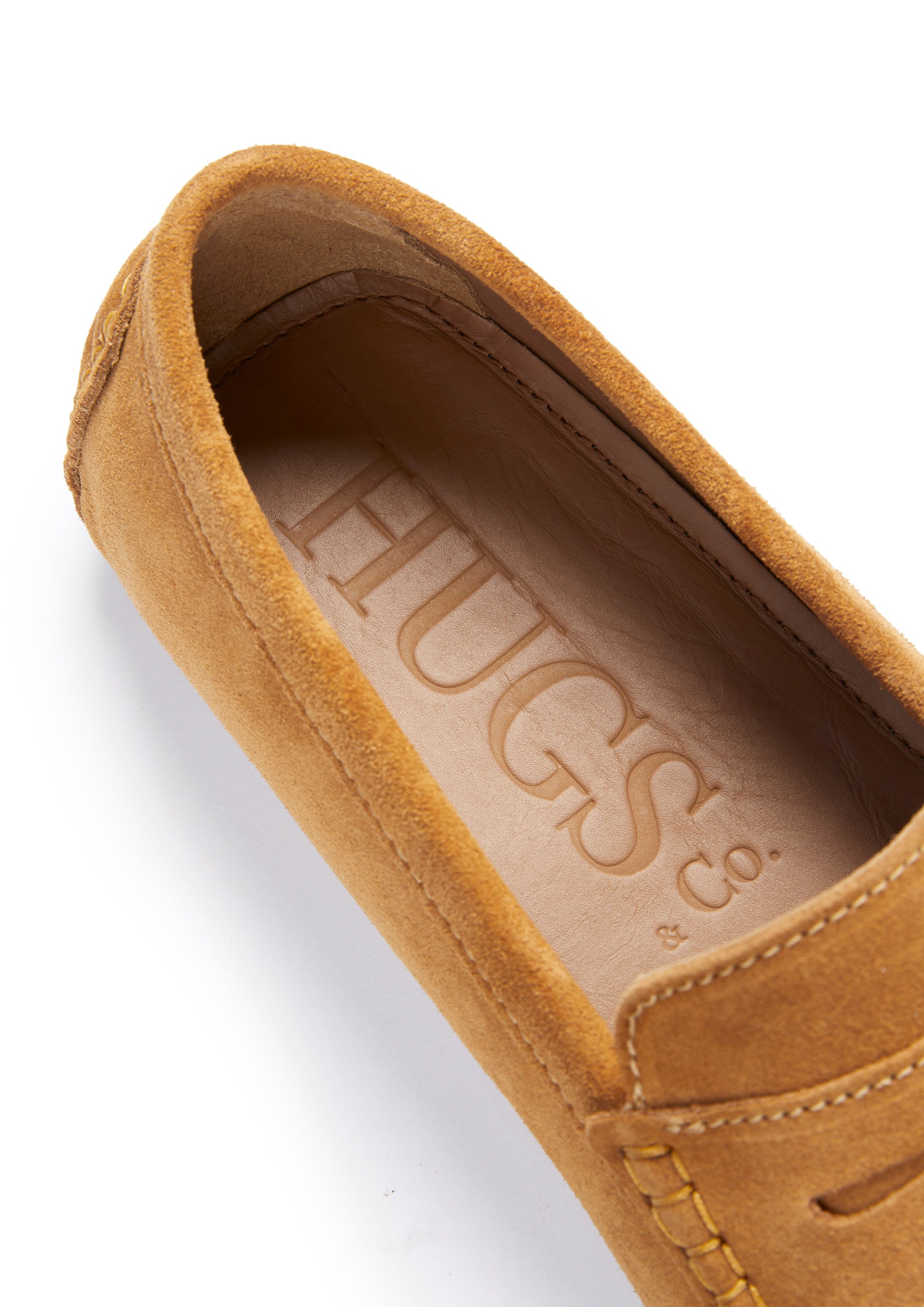 Brown suede shoe with 'HUGS' branding on a white background