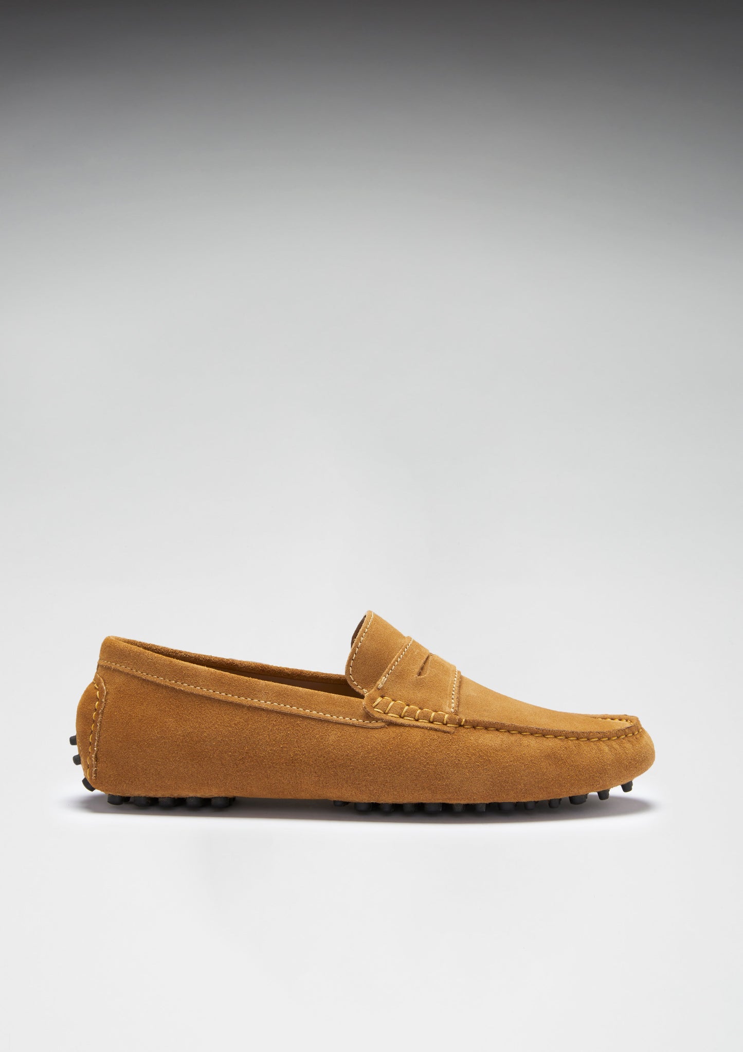 Brown loafer shoe on a gray background