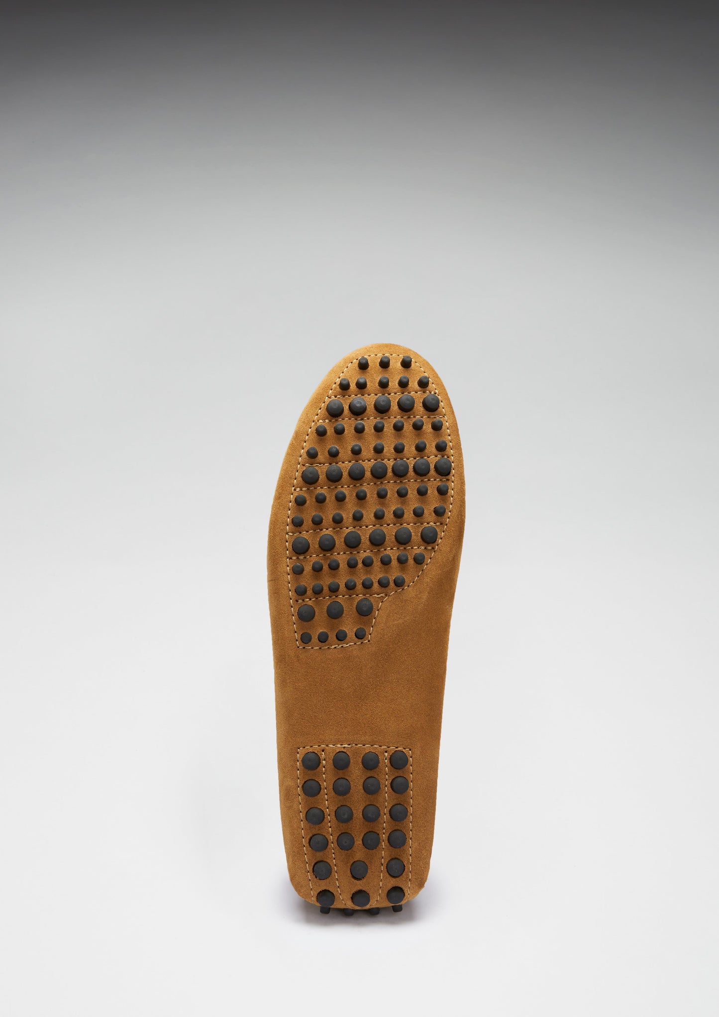 Brown shoe insole with textured sole on a gray background