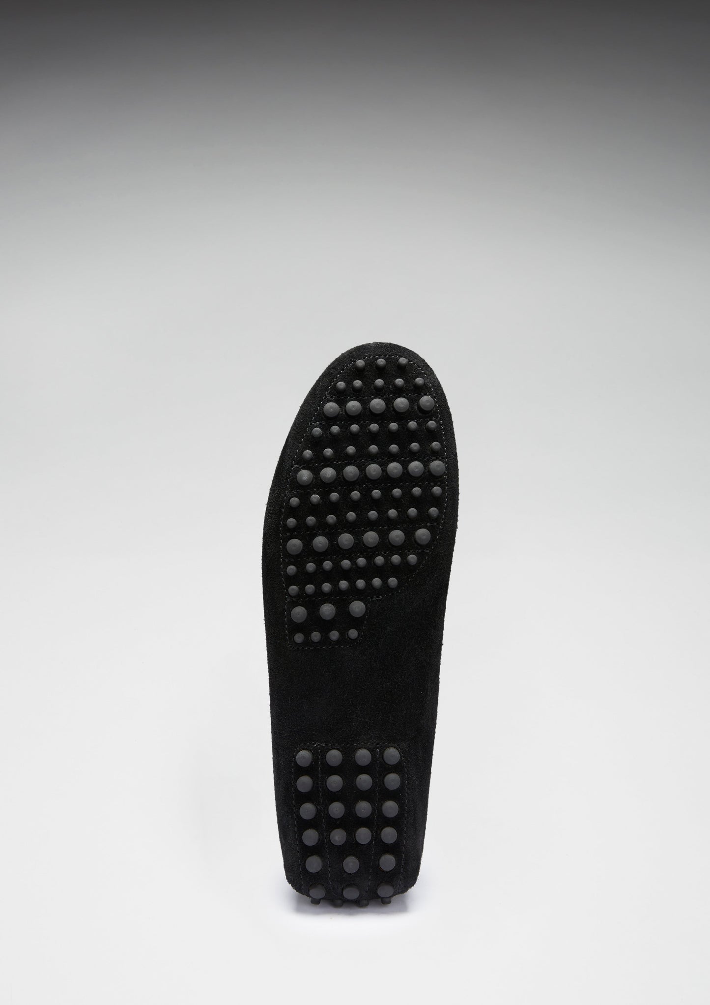 Black shoe sole with textured pattern on a white background