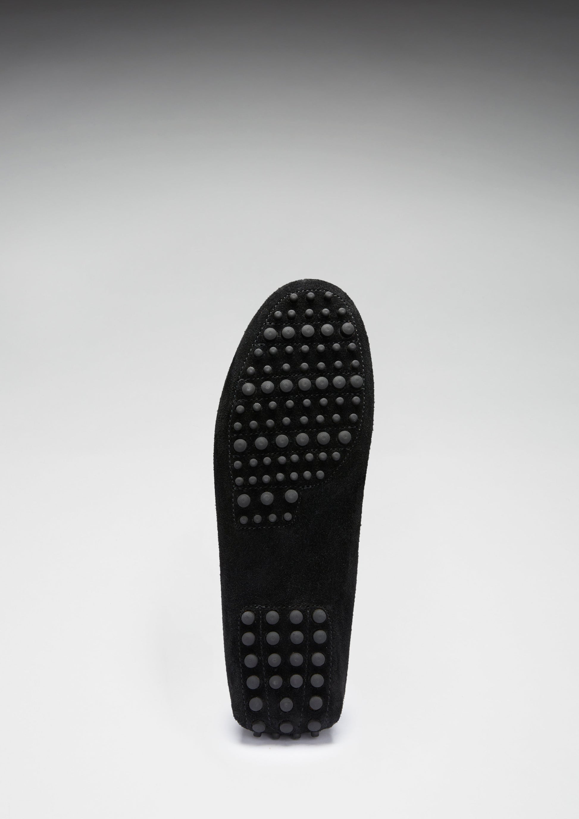 Black shoe sole with textured pattern on a white background