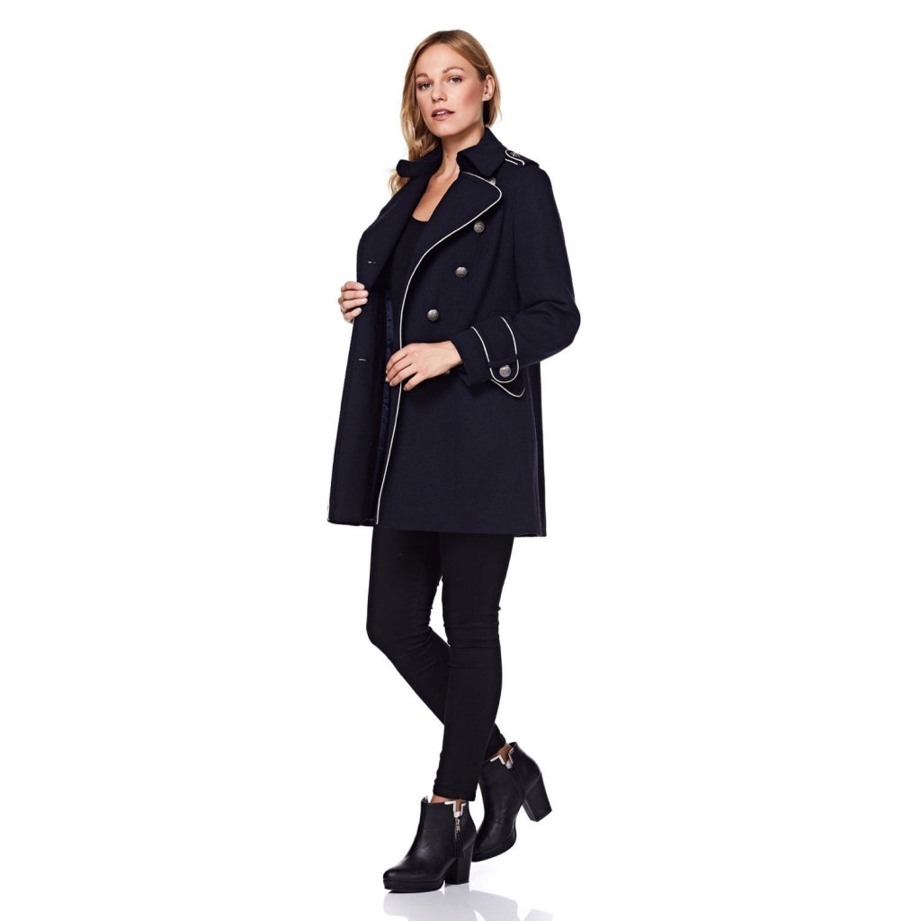 Woman wearing a navy coat on a white background