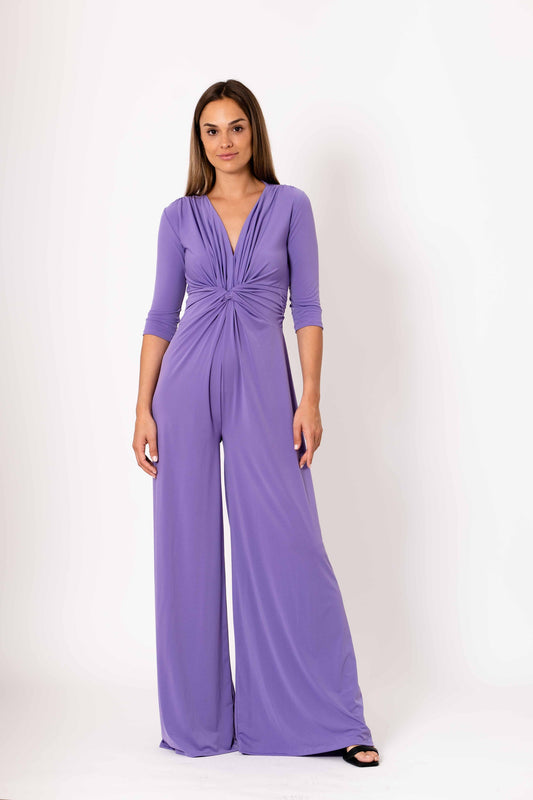Woman wearing a purple jumpsuit on a white background