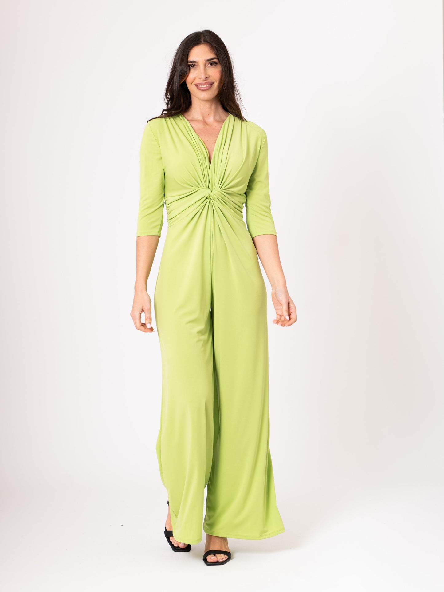 Woman wearing a green jumpsuit on a white background
