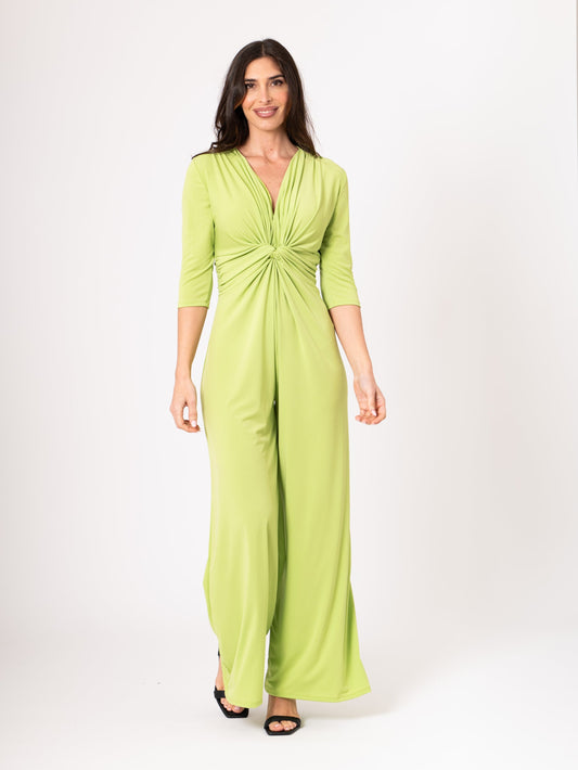 Woman wearing a green jumpsuit on a white background