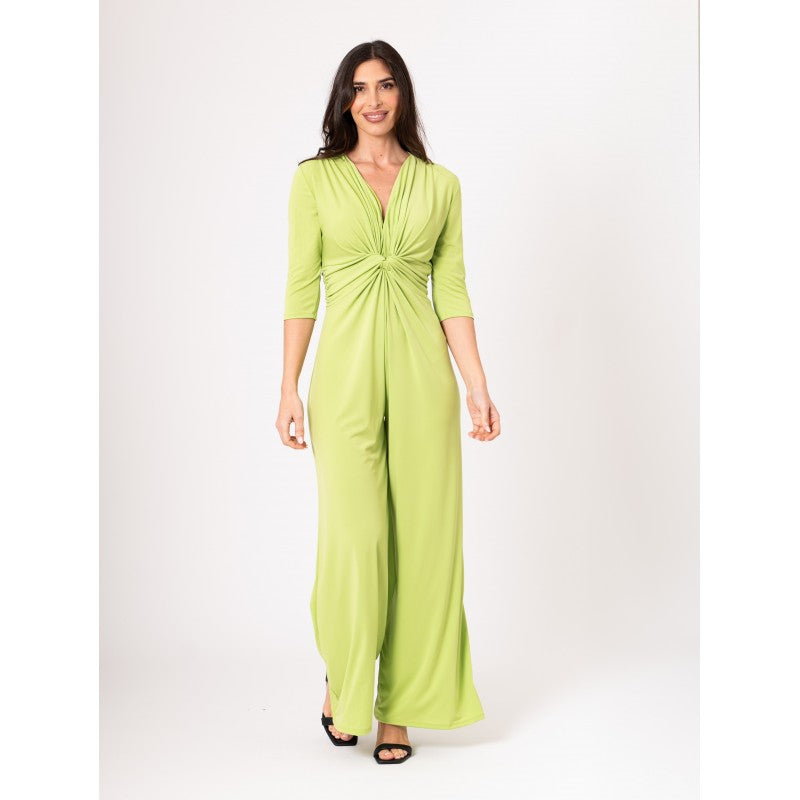 Woman wearing a green jumpsuit on a white background