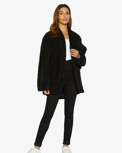 Woman wearing a black outfit with a white background