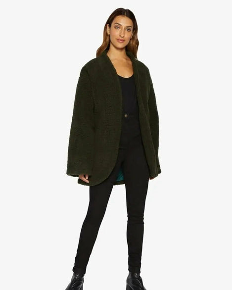 Woman wearing a green coat on a white background