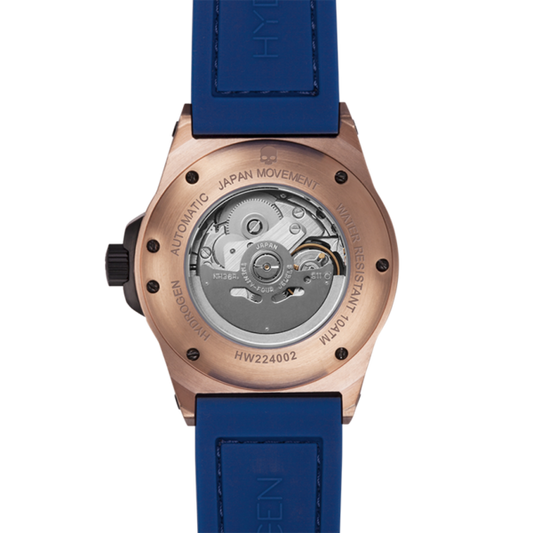 Watch with blue strap and rose gold case on a white background