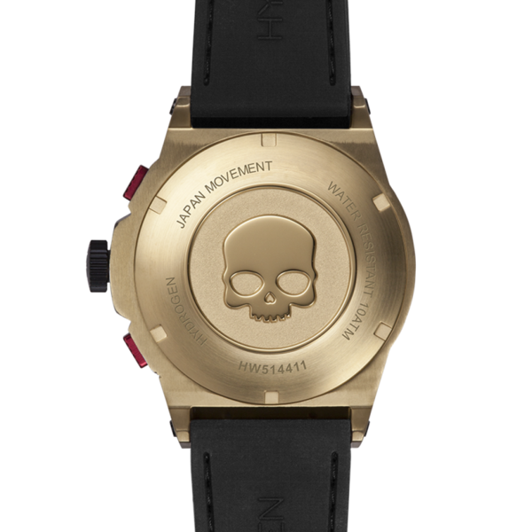 Gold watch case with skull design and black strap on a white background