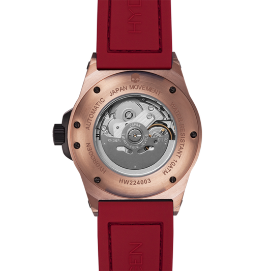 Watch with red strap and rose gold case on a white background