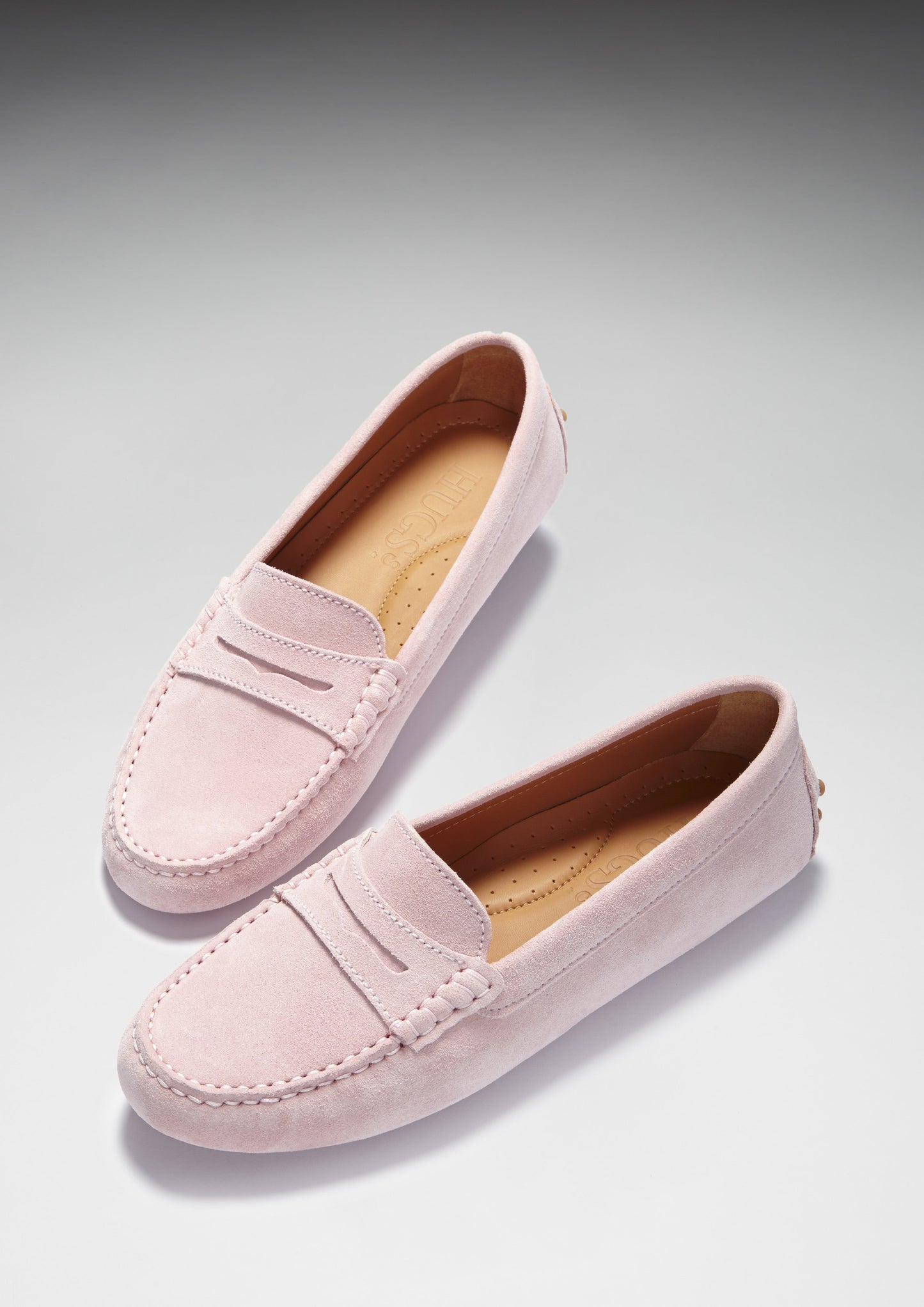 Pink loafers on white background
