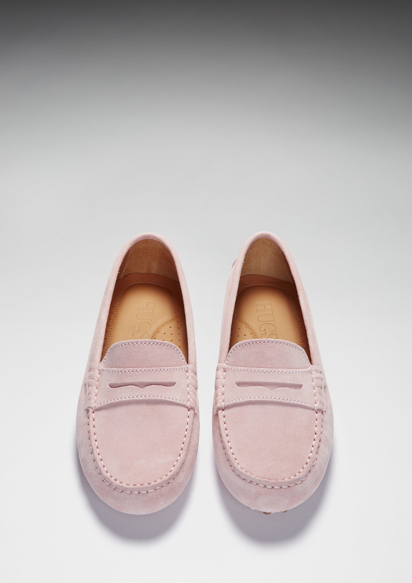 Pink loafers on white background
