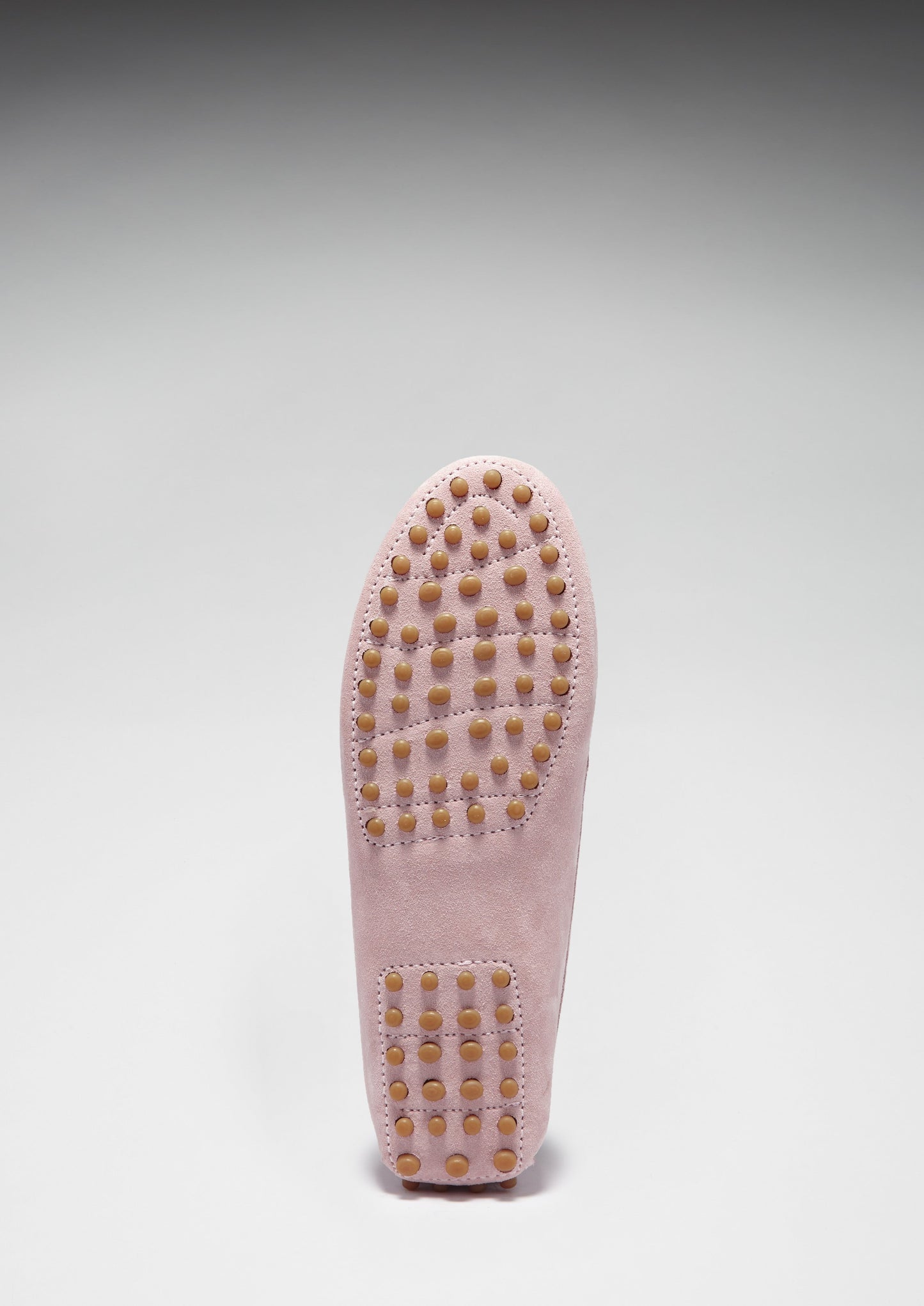 Pink loafers on white background sole view