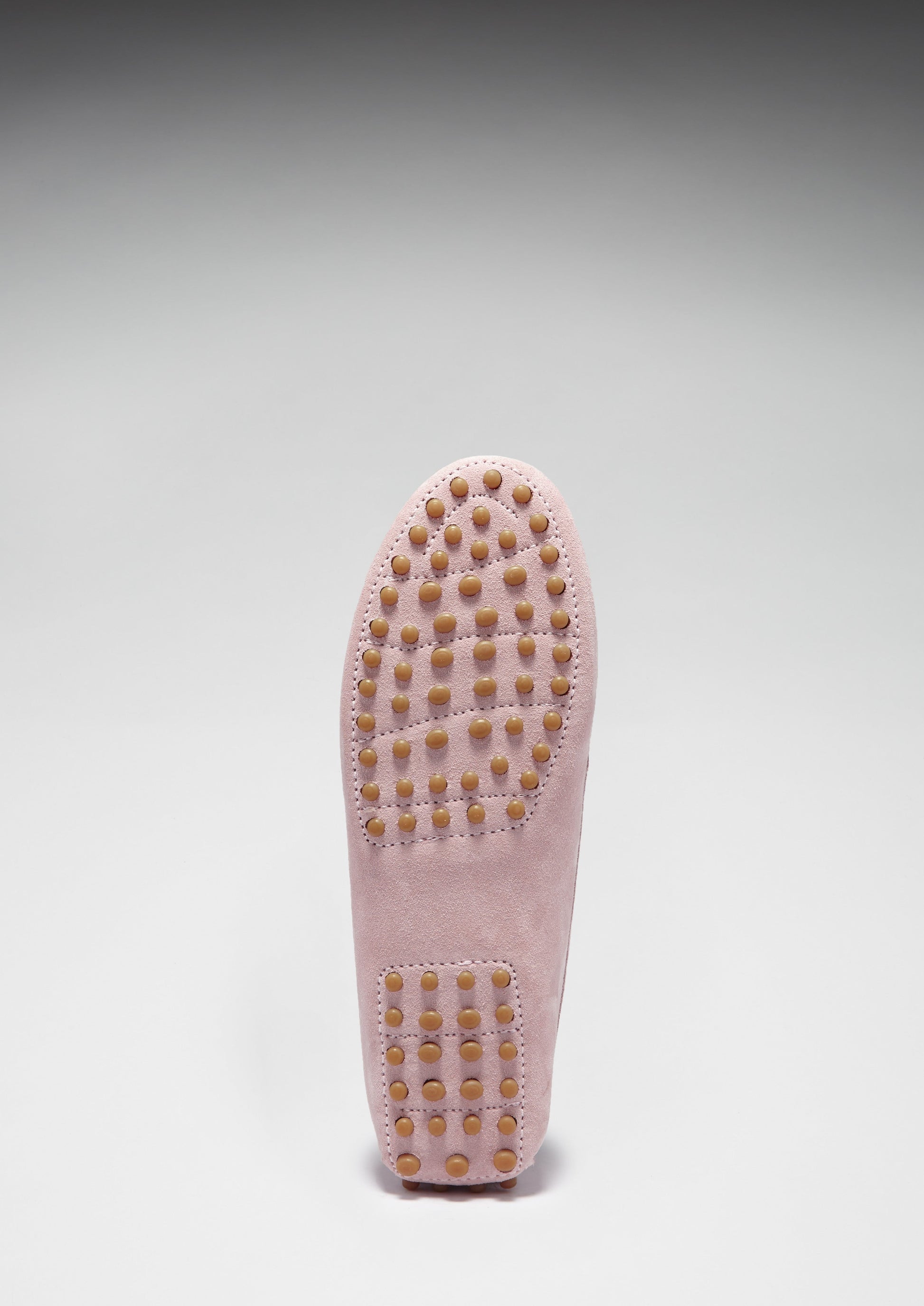 Pink loafers on white background sole view