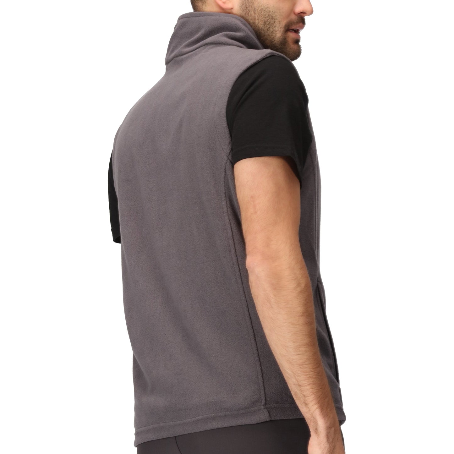 Man wearing a gray sleeveless vest over a black shirt on a white background