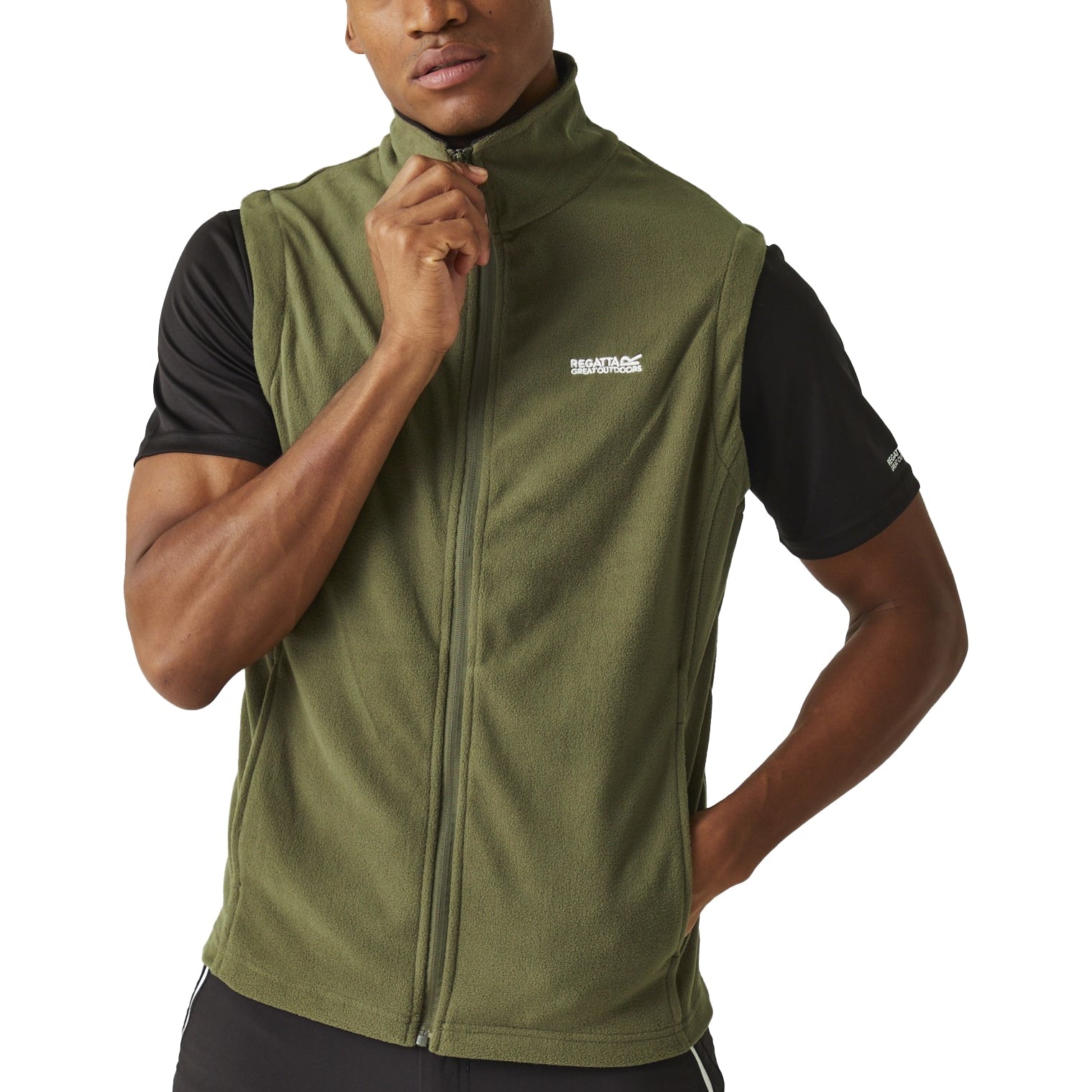 Man wearing a green vest with a brand logo on a white background