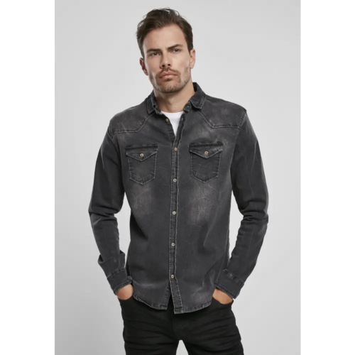 Man wearing a black denim shirt against a gray background