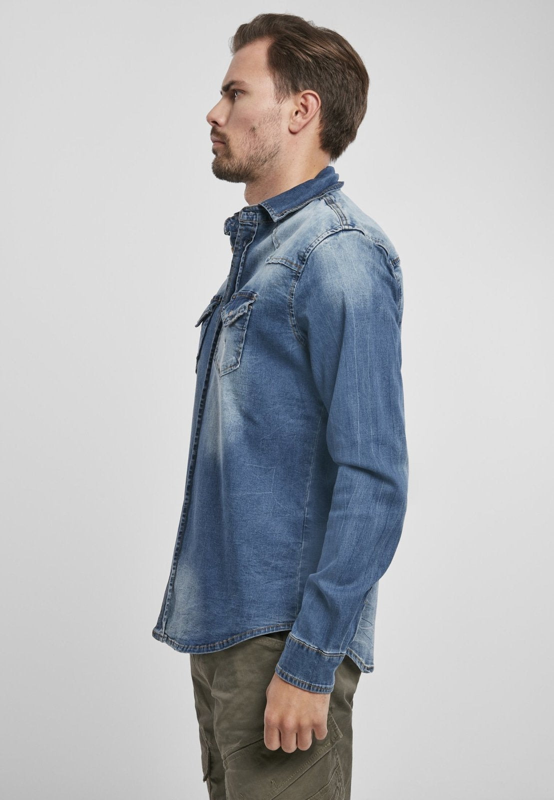 Man wearing a blue denim shirt on a white background