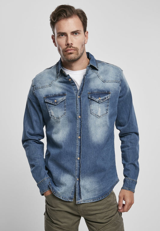 Man wearing a blue denim shirt on a light gray background