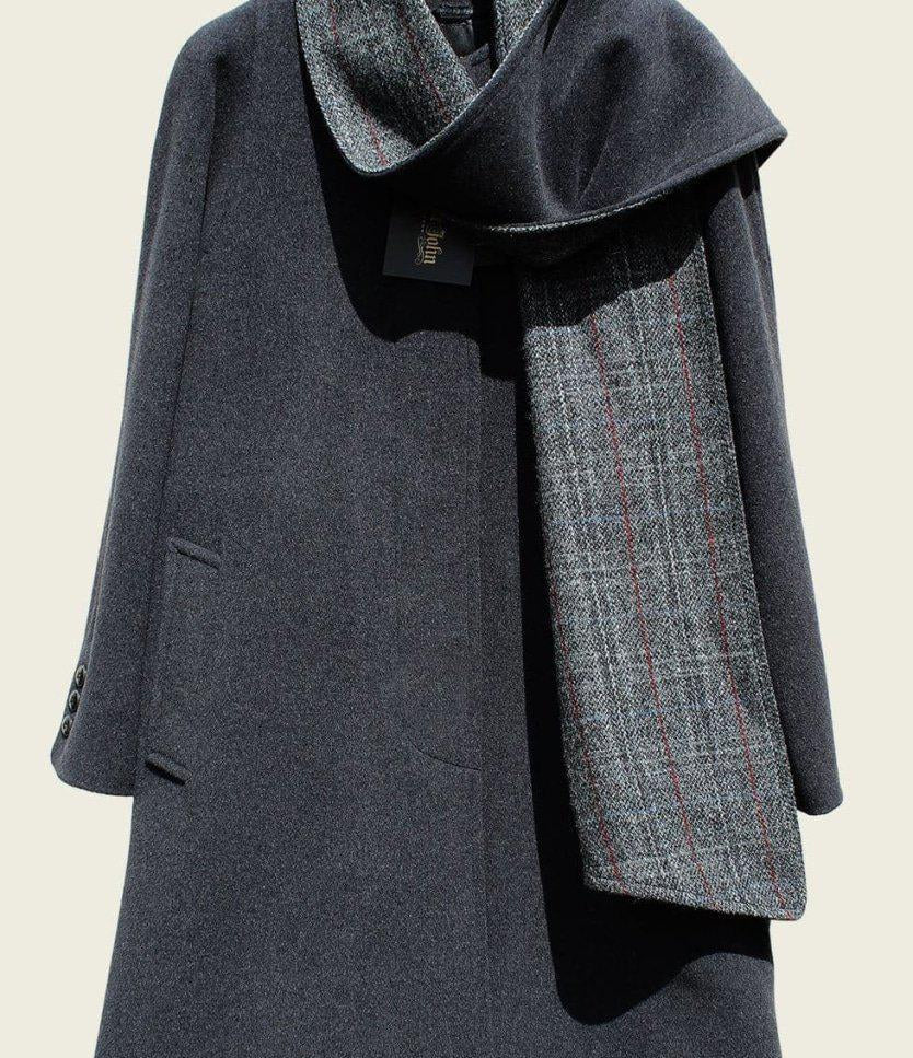 Gray coat with a matching scarf on a beige background