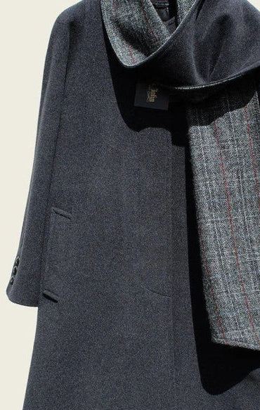 Gray coat with a matching scarf on a beige background