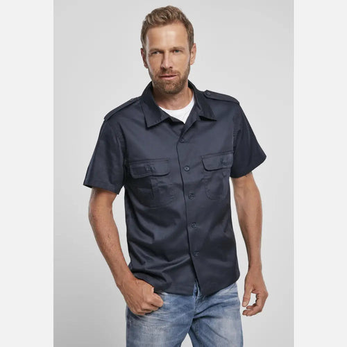 Man wearing a navy short-sleeve shirt against a plain background