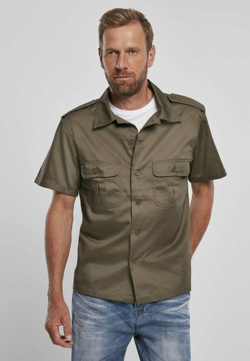 Man wearing a green short-sleeve shirt with a collar on a gray background