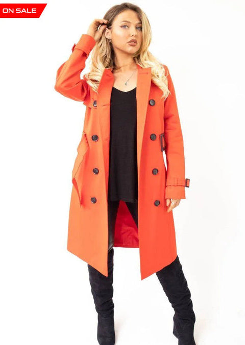 Woman wearing an orange coat with a 'On Sale' label above her, on a white background.