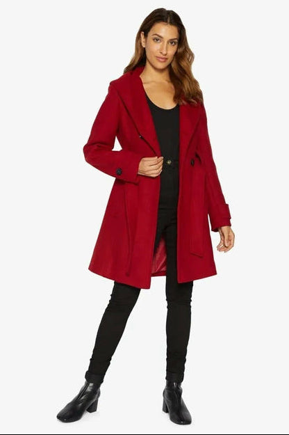Woman wearing a red coat on a white background