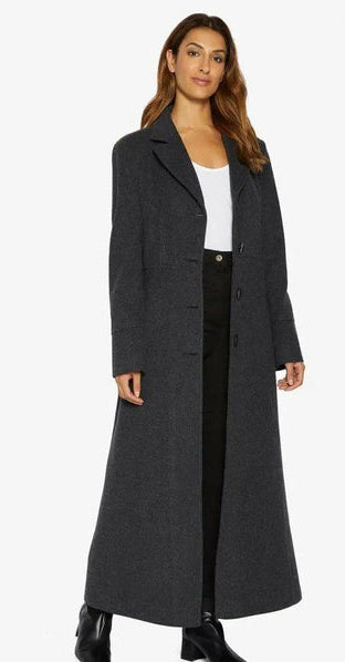 Woman wearing a long dark gray coat on a white background