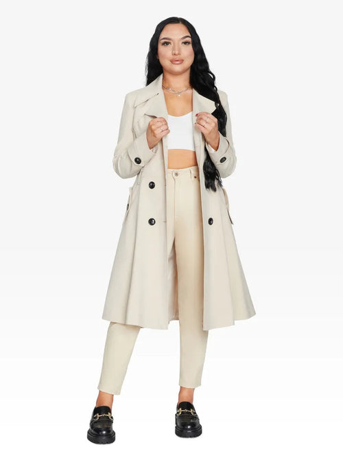 Woman wearing a beige trench coat on a white background
