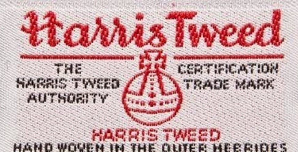 Harris Tweed certification logo on fabric with red text and white background