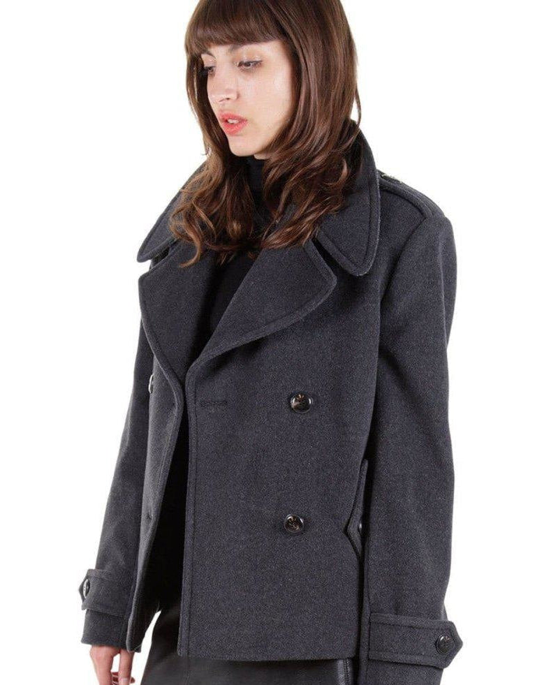 Woman wearing a gray coat on a white background