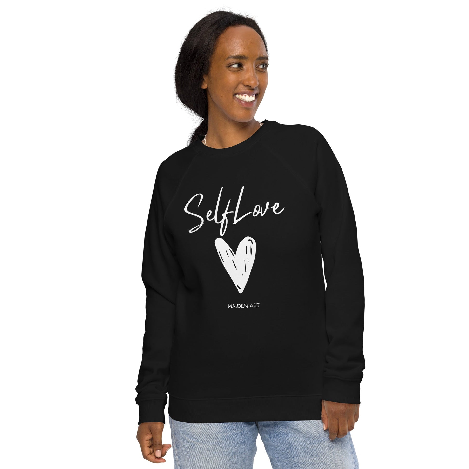 Woman wearing a black sweatshirt with 'Self Love' and a heart design on a white background