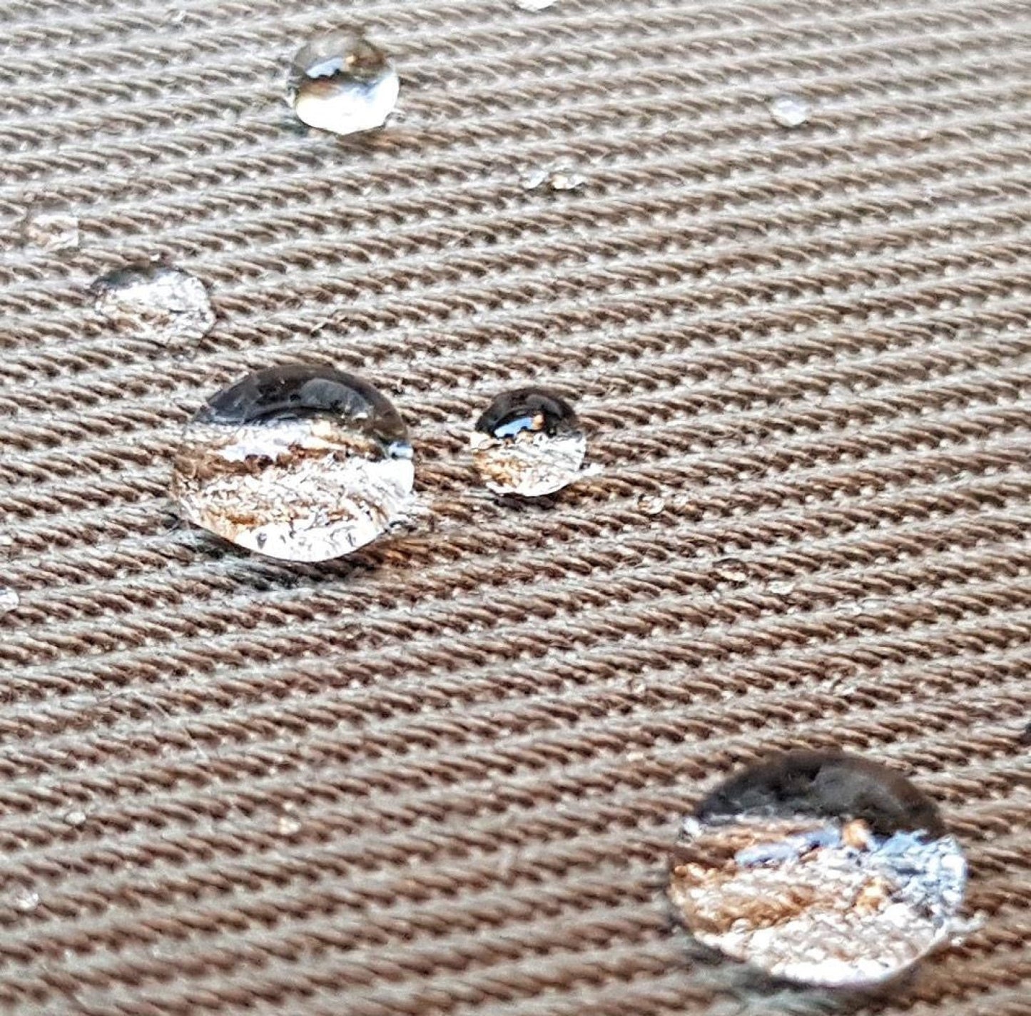 Water droplets on a textured brown surface