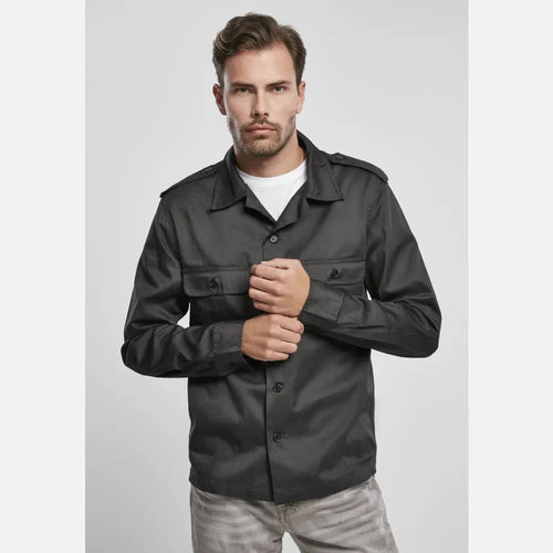 Man wearing a dark gray jacket on a light gray background