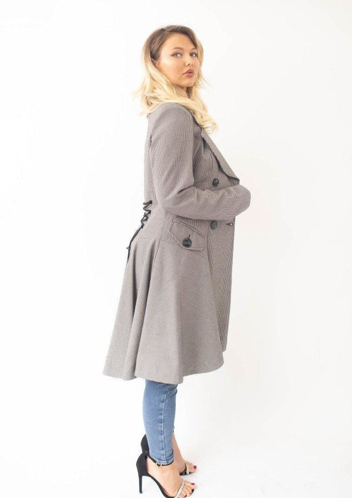 Woman wearing a gray coat on a white background
