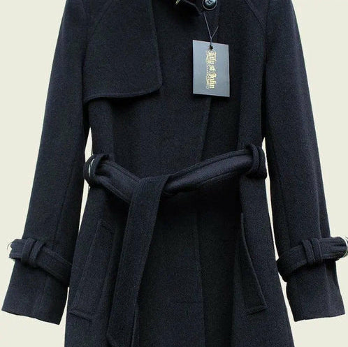Navy blue coat with a belt and tag on a beige background